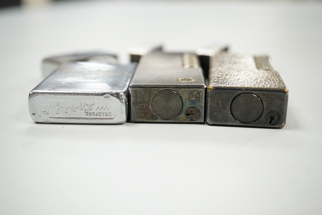 Two Dunhill rollagas silver plated lighters, barley pattern and rusticated 6.5cm long and a U.S.S. Coronado LPD-11, zippo lighter (3)